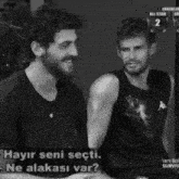 a black and white photo of two men with the words hayir seni secti on the bottom