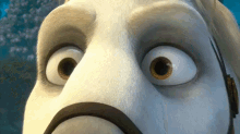 a close up of a cartoon character 's face with huge eyes