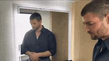 a man standing in front of a mirror looking at his reflection