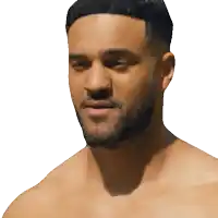 a shirtless man with a beard looks to the side