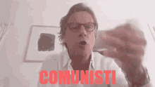 a man wearing glasses says communisti in red
