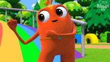 a cartoon character is standing in front of a rainbow in a park .