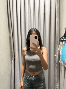 a woman taking a selfie in a dressing room