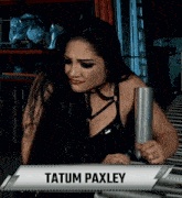 a female wrestler named tatum paxley holds a metal object