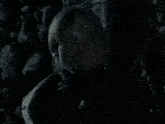 a close up of a man 's face in a dark room