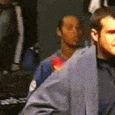 a blurry picture of a man in a blue shirt and tie