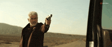 a man holding a gun in front of a sign that says ' eastern world '