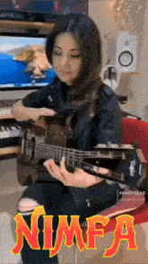 a woman is playing a guitar in front of a computer and the word nimfa is on the bottom right