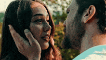 a man is touching a woman 's face with his finger