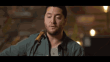 a person is playing a guitar in a blurry photo .
