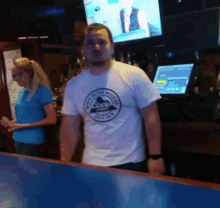 a man wearing a t-shirt that says ' black and white ' on it stands next to a woman