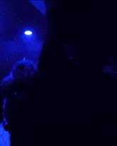 a man is lighting a cigarette with a lighter with a letter k on it