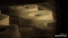a bunch of donuts are sitting on a table and the words made in animotica are on the bottom right