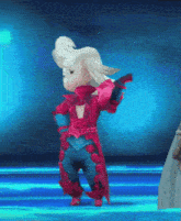 a cartoon character in a red and blue outfit is standing on a blue background