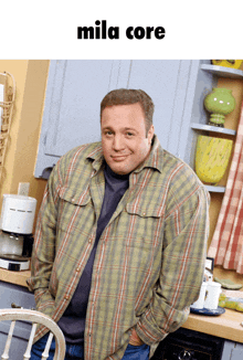 a man in a plaid shirt is standing in front of a coffee maker with the words mila core above him