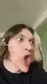 a man is making a funny face with his tongue sticking out .