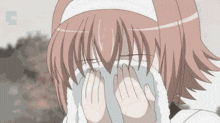 a girl with pink hair is covering her face with a white cloth