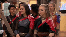a group of people are dressed in armor and holding swords in front of a screen that says nick