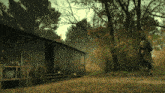 a person standing in front of a screened in porch in the woods