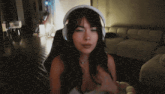 a woman wearing headphones is sitting in a living room