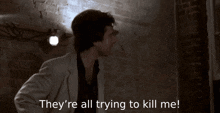 a man in a white suit says " they 're all trying to kill me "