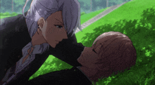 a couple of anime characters are laying on the grass