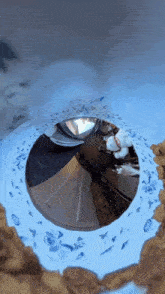 a reflection of a person in a mirror with a blue and white floral design