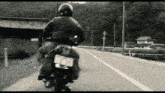 a person riding a motorcycle with a license plate that has 215 on it