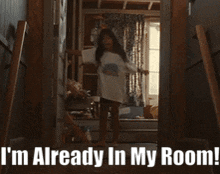 a little girl standing in a doorway with the words " i 'm already in my room " above her