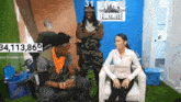 a woman is sitting in a chair with a fortnite sign behind her