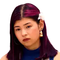 a woman with purple hair has a flower in her ear