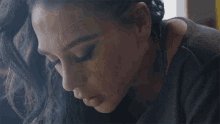 a close up of a woman 's face with smoke coming out of her nose and mouth .