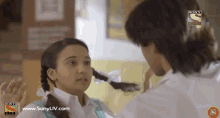 a boy and a girl are looking at each other on a sony tv channel