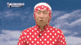a man wearing a red and white polka dot outfit with a headband