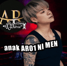 a woman with a tattoo on her arm and the words anak ar01 ni men on the bottom