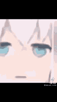 a close up of a person 's face with blue eyes