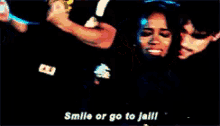 a man and a woman are hugging with the words smile or go to jail written on the bottom