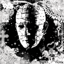 a black and white photo of a man 's face surrounded by flowers and a cross with the words picmix at the bottom