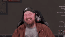 a man with a beard wearing a bandana with a skull and crossbones on it is smiling