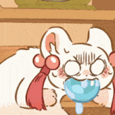 a cartoon drawing of a cat with a blue object in its mouth ..
