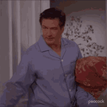 a man in pajamas is standing in a doorway .