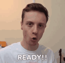 a young man wearing a white shirt that says ready