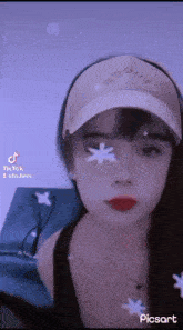 a woman wearing a hat and a necklace is taking a selfie .