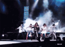 a group of people dancing on a stage with a rbd.gif watermark on the bottom
