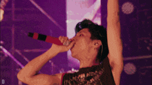 a man singing into a microphone while wearing a black tank top with a skull on it