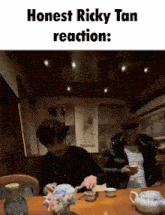 two men are sitting at a table with the caption honest ricky tan reaction :
