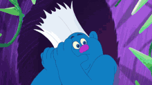 a blue troll with white hair and a pink nose is standing in a tunnel
