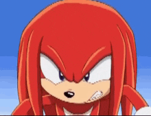 a close up of knuckles the echidna from sonic the hedgehog making a face .
