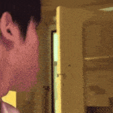 a close up of a person 's ear with a door in the background