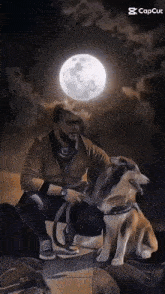 a man is kneeling next to a dog under a full moon .